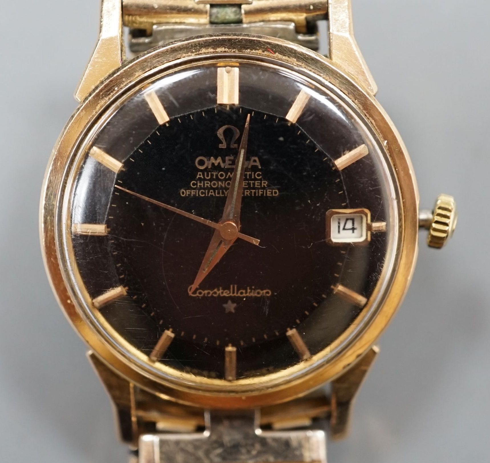 A gentleman's steel and gold plated Omega Automatic Constellation black dial wrist watch, on associated bracelet, case diameter 34mm (winding crown a.f.).